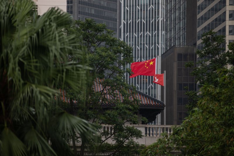 The People's Republic of China flag and the Hong Kong SAR flag are hoisted on the Court of Final Appeal in the Central District in Hong Kong, China, on October 28, 2020. A total of five foreign judges have now resigned from the court this year. Photo by Jerome Favre/EPA-EFE