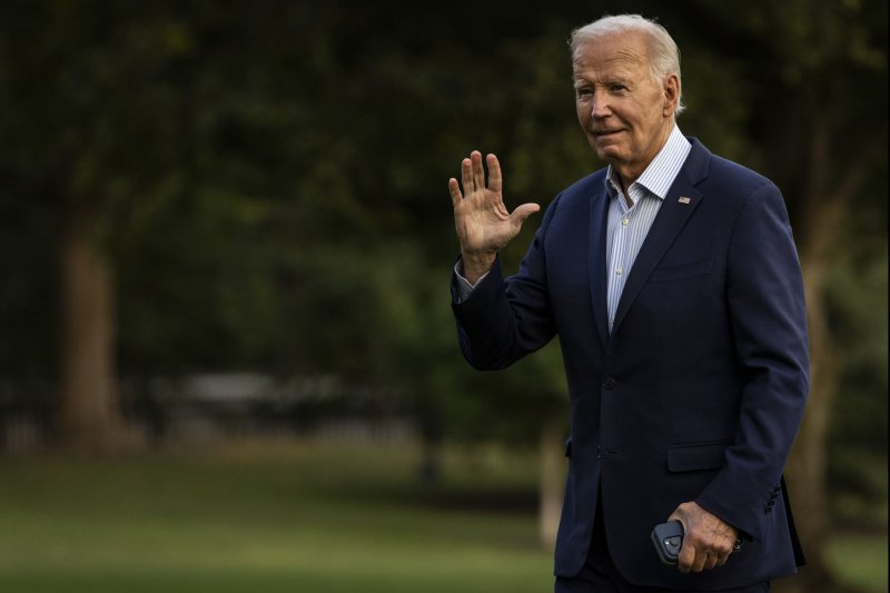 President Joe Biden walks across the South Lawn after landing at the White House Thursday following his return from Wisconsin where he highlighted his administration's clean energy investments in rural electric cooperatives. Photo by Samuel Corum/UPI