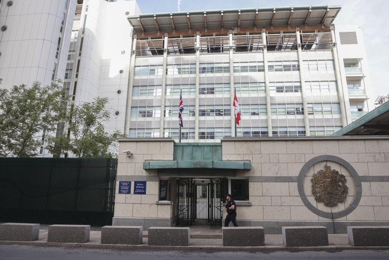 A police officer patrols outside a compound shared by the British and Canadian embassies in Moscow on Friday after the Federal Security Service said it had revoked the diplomatic credentials of six Britons working at the mission on suspicion of spying and "threatening Russia's security." Photo by Sergei IlnitskyEPA-EFE