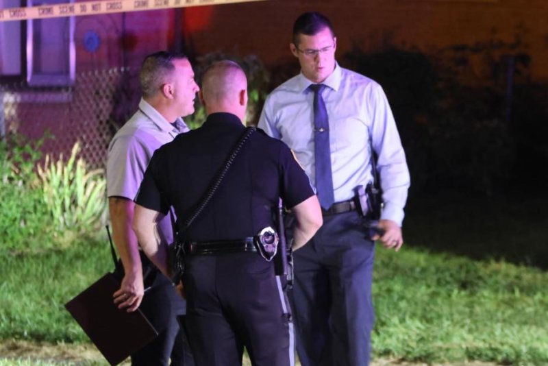 Des Moines Police Department officers and investigators examine the scene in Des Moines early Monday at which two officers were shot and a suspect killed. Police said the suspect, identified as a 37-year-old male, opened fire with a handgun after Des Moines police officers attempted to take the driver into custody. Officers returned fire and killed the suspect, police said. Photo courtesy of Des Moines Police Department