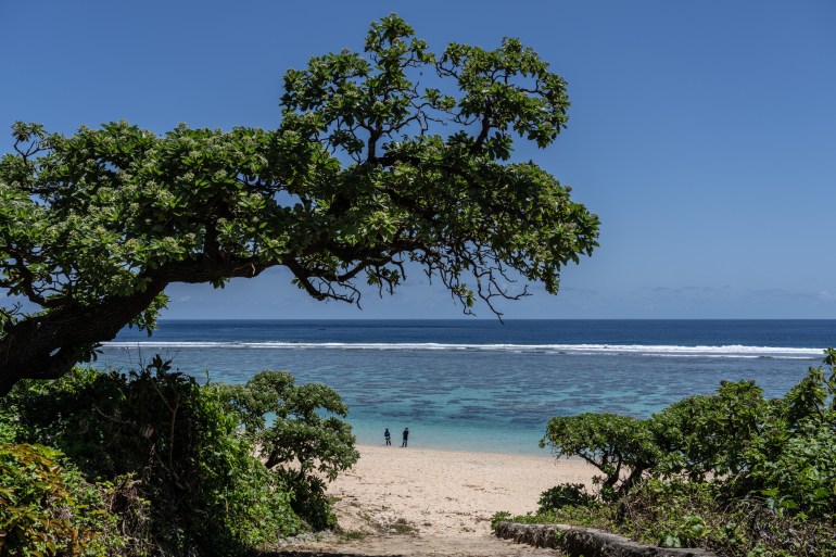 A couple relax on a beach in Miyakojima, Okinawa, Japan [Carl Court/Getty Images]