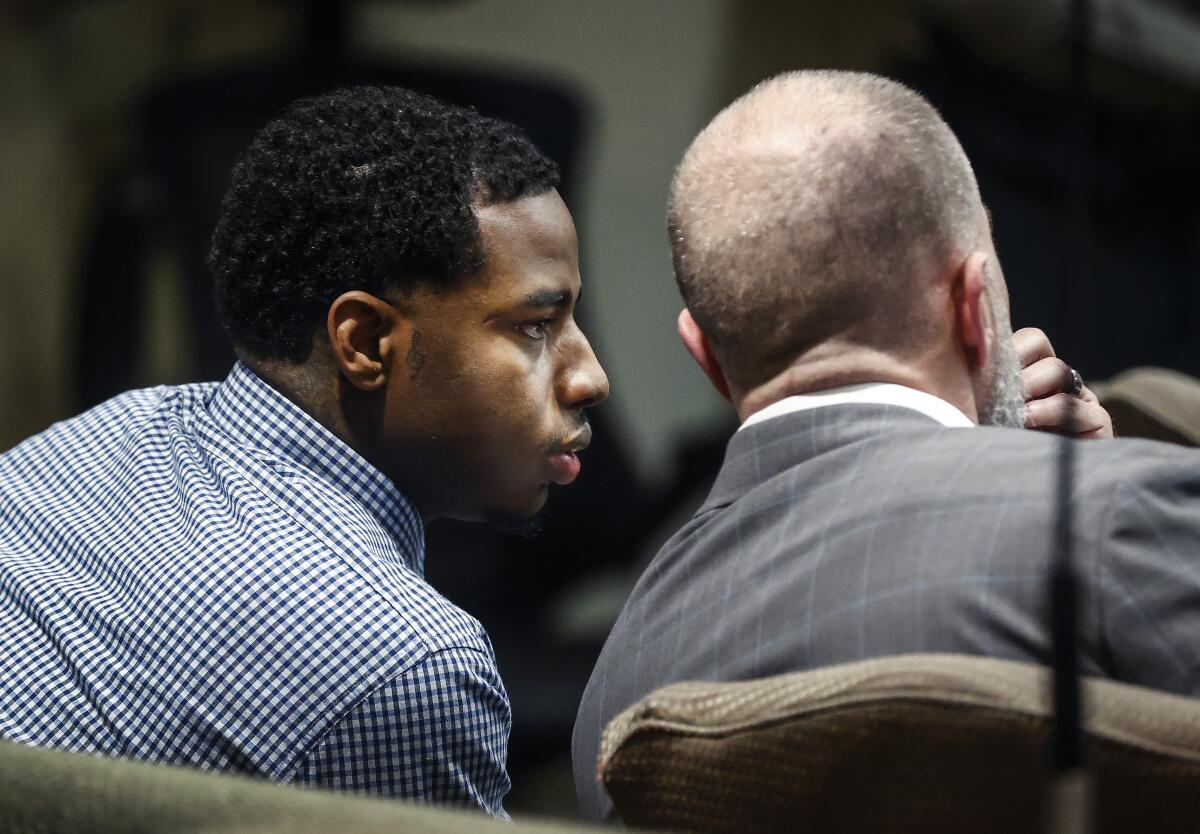 Defendant Justin Johnson, left, appears in court as the murder trial of rapper Young Dolph begins in Memphis, Tenn.