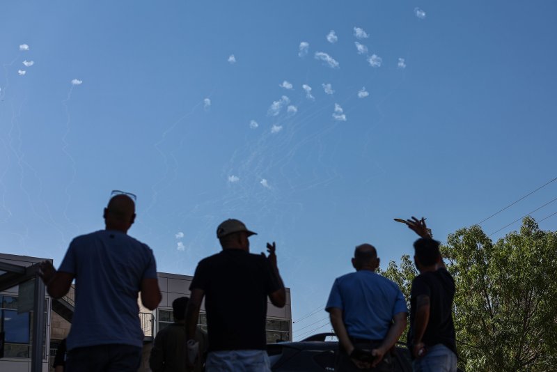 Residents of Safed in upper Galilee in northern Israel look on Wednesday as the country's Iron Dome air defense system intercepts missiles fired from south Lebanon. The Israeli military identified approximately 40 missiles crossing from Lebanon into Israeli territory. EPA-EFE/ATEF SAFADI