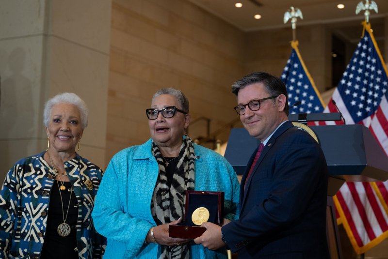 Family members of the "Hidden Figures" accept a medal from Speaker of the House Mike Johnson, R-La., at a Congressional Gold Medal Ceremony honoring NASA's Hidden Figures in Emancipation Hall in the U.S. Capitol Wednesday. Photo by Annabelle Gordon/UPI