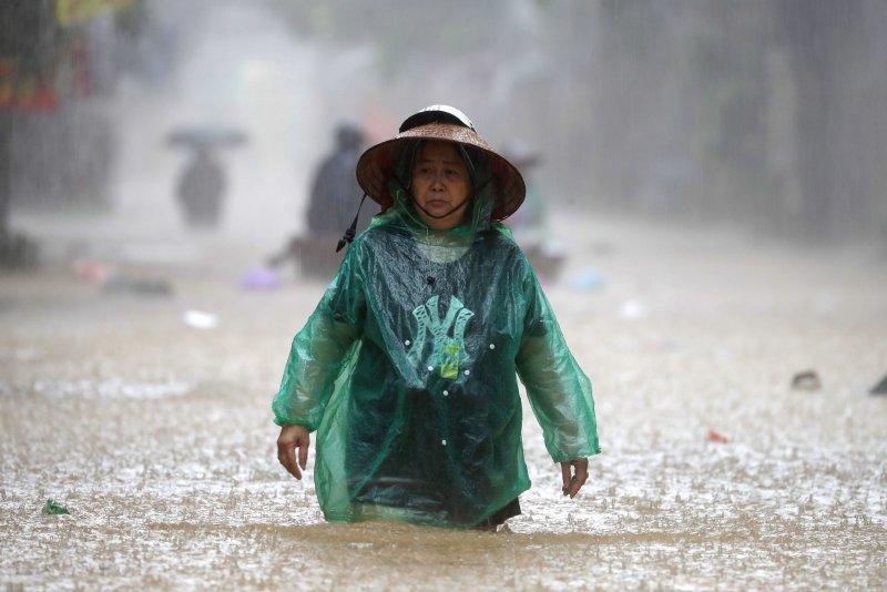 A woman wades through the flood waters in a street of Hanoi, Vietnam, Friday. Typhoon Yagi has caused severe flooding in Hanoi and devastation across pats of Asia. EPA-EFE/LUONG THAI LINH.