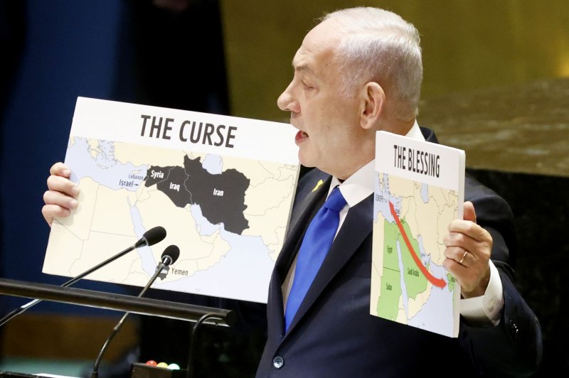 Prime Minister of Israel Benjamin Netanyahu holds two maps with messages when he speaks at the U.N. General Assembly 79th session General Debate in U.N. General Assembly Hall at the United Nations Headquarters on Friday in New York City. Photo by John Angelillo/UPI