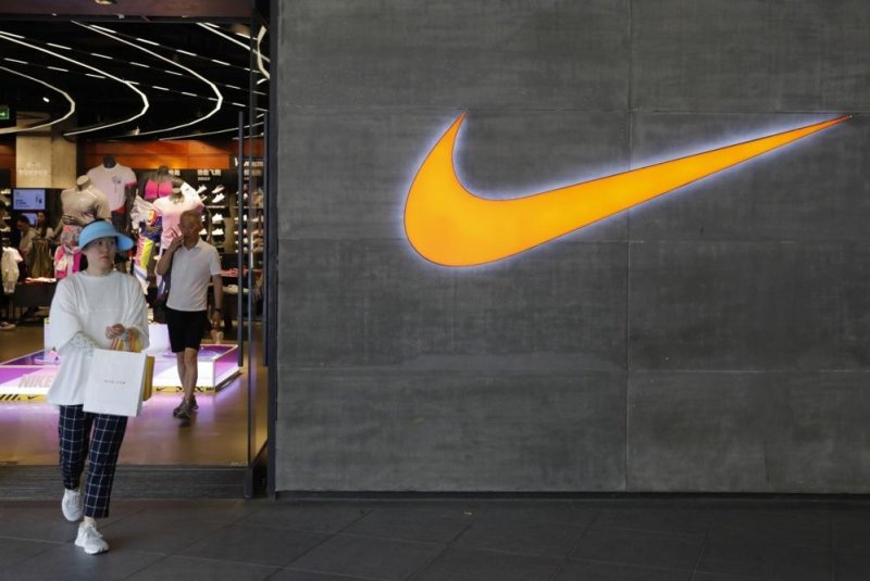 A Chinese woman walks past a Nike logo outside a Nike store in Beijing, China, on May 22, 2019. Nike announced a new president and CEO of its company on Thursday. File Photo by Wu Hong/EPA-EFE