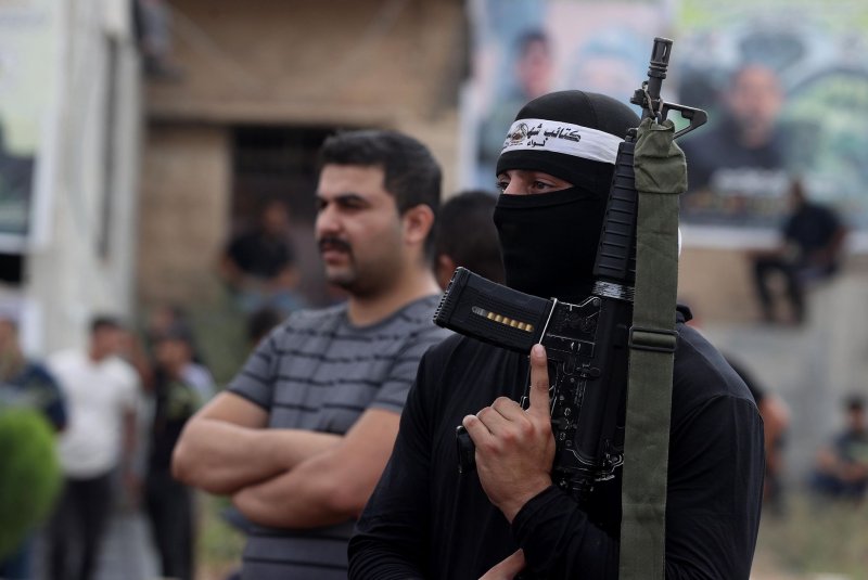 A Palestinian fighter attends the funeral ceremony of eight Palestinians who died as a result of the Israeli army's 10-day-long attacks and raids on Jenin, West Bank, on Friday. Photo by Ismael Ahmad/UPI