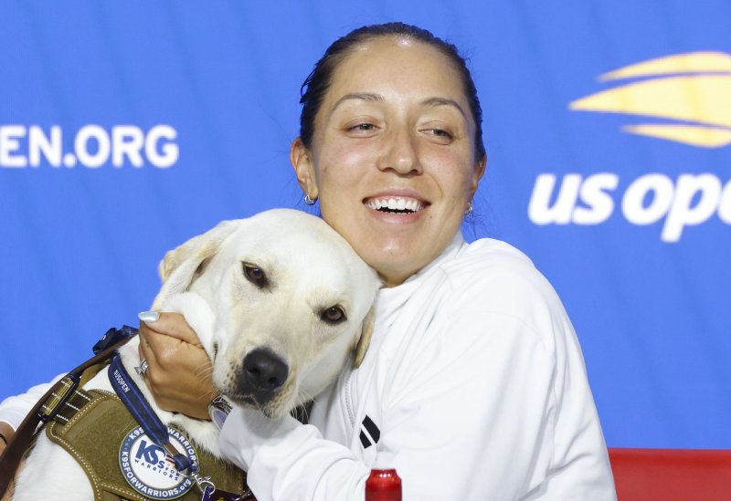 Jessica Pegula holds Ace, a service dog representing K9S For Warriors Service Dogs In-Training sponsored by Jessica Pegula, when she speaks at a press conference in Arthur Ashe Stadium at the 2023 US Open Tennis Championships in at the USTA Billie Jean King National Tennis Center on Friday, August 25 in New York City. Photo by John Angelillo/UPI