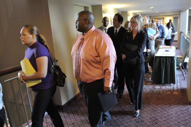 Employment seekers line up as a job fair opens on August 24, 2011, in Lombard, Illinois. Those seeking initial unemployment benefits dropped to 218,000 last week. File Photo by Brian Kersey/UPI