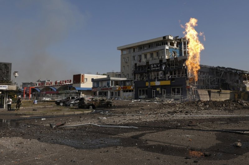 Ukrainian rescuers work at the site of a missile strike on a shopping mall in Kharkiv, northeastern Ukraine September 1 amid the Russian invasion. At least 40 people have been injured, including five children, after a Russian rocket attack hit several civilian sites in Kharkiv EPA-EFE/SERGEY KOZLOV