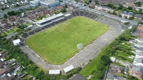 PA Media Aerial shot of grass pitch surrounded by residential housing 