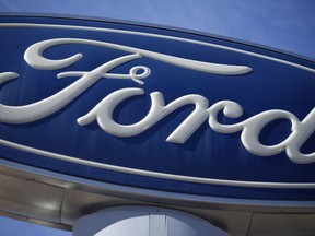 FILE - A Ford company logo on a sign at a Ford dealership in southeast Denver, Oct. 24, 2021.