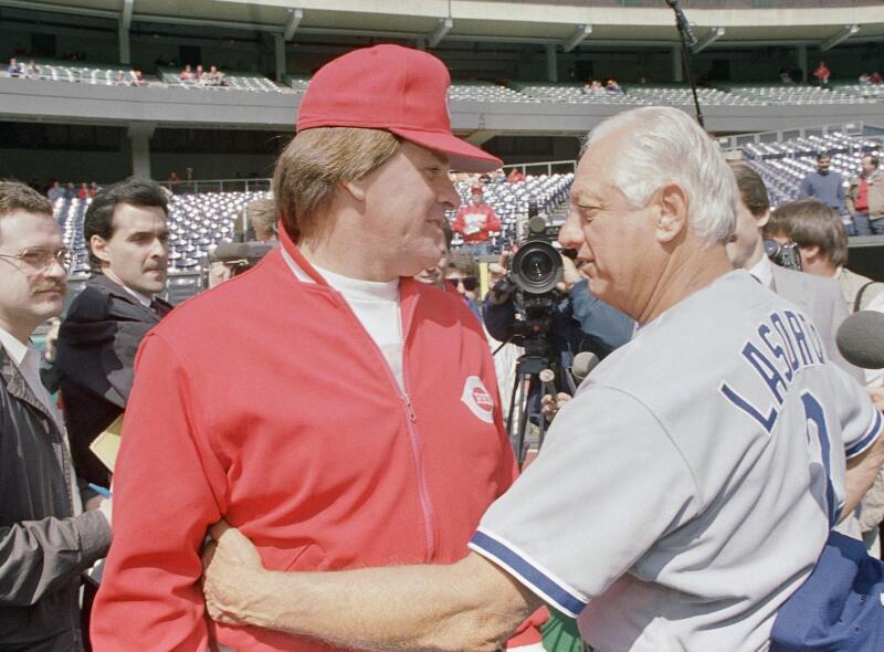 Cincinnati Reds manager Pete Rose and Dodgers manager Tommy Lasorda hug before opening day on April 3, 1989.