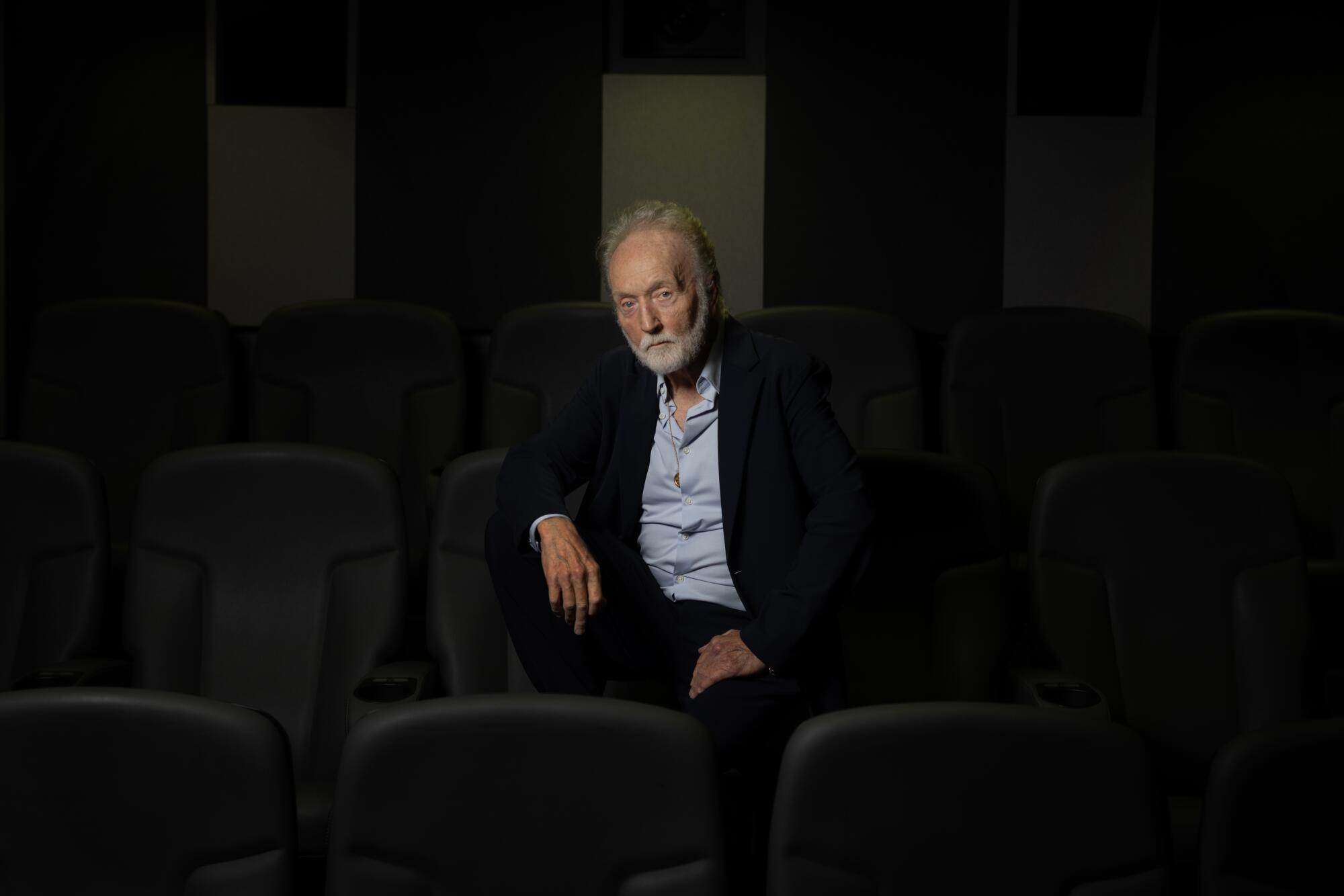 A man sits in an auditorium.