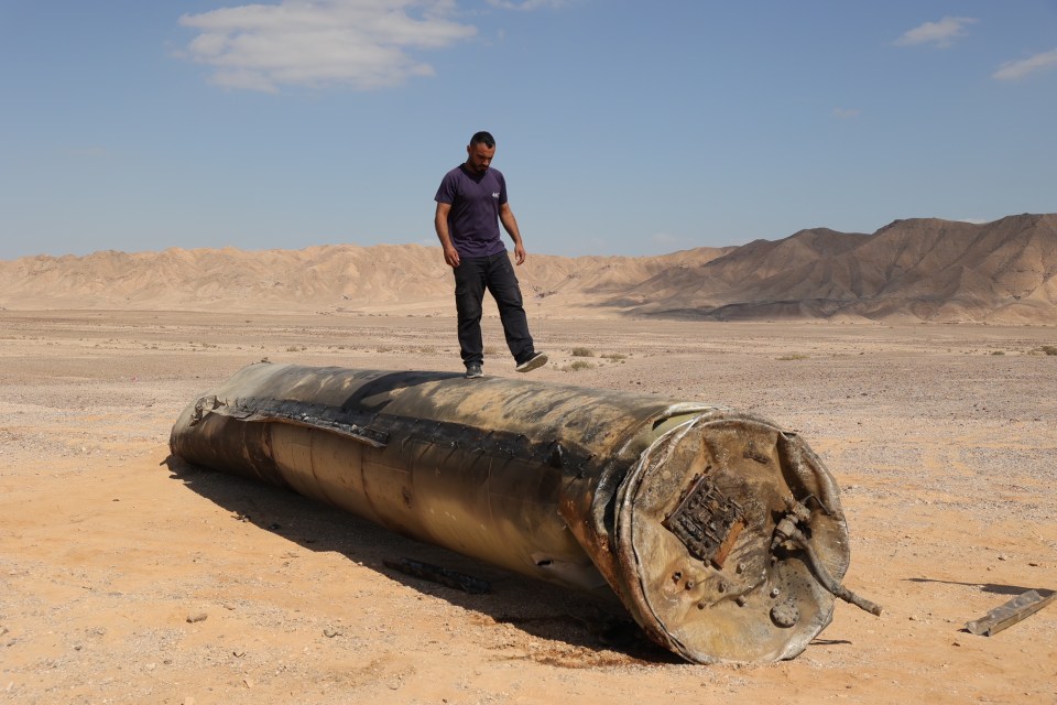 An Israeli stands on an Iranian missile following the blitz