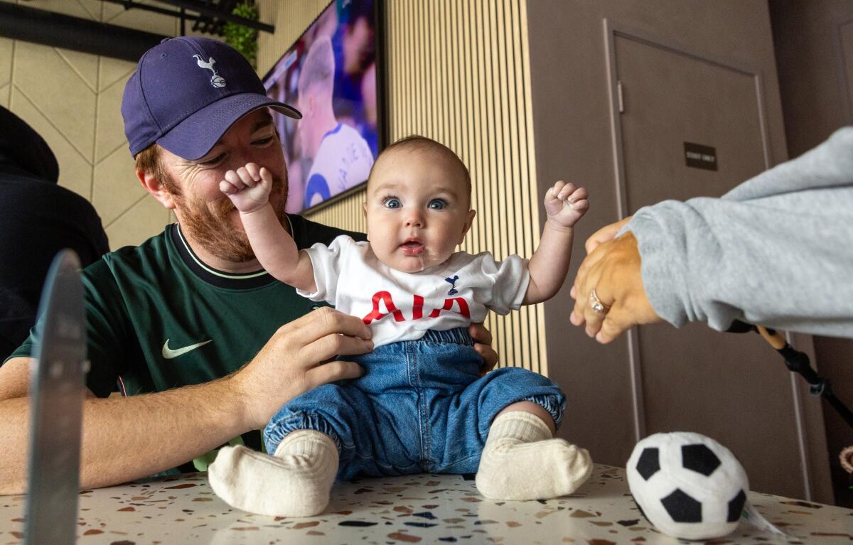 Six-month-old Conor hangs out with his parents Jimmy and Allie while watching a game at N17 The Lane in Culver City.