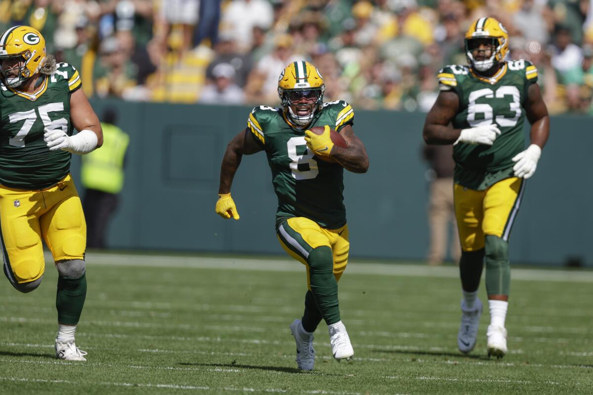 The Packers' Josh Jacobs (8) runs free in a game against the Colts.