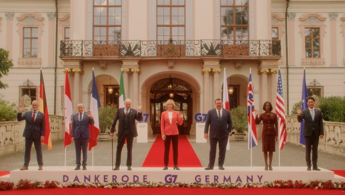 People waving in front of a building