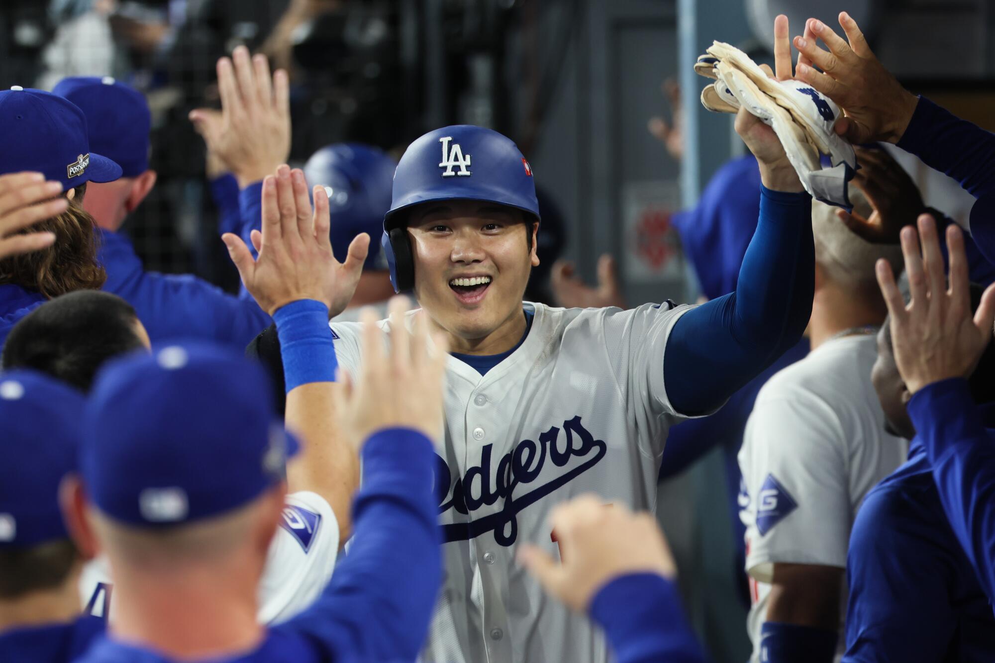 Shohei Ohtani celebrates in the dugout after hitting a three-run home run in the second inning.