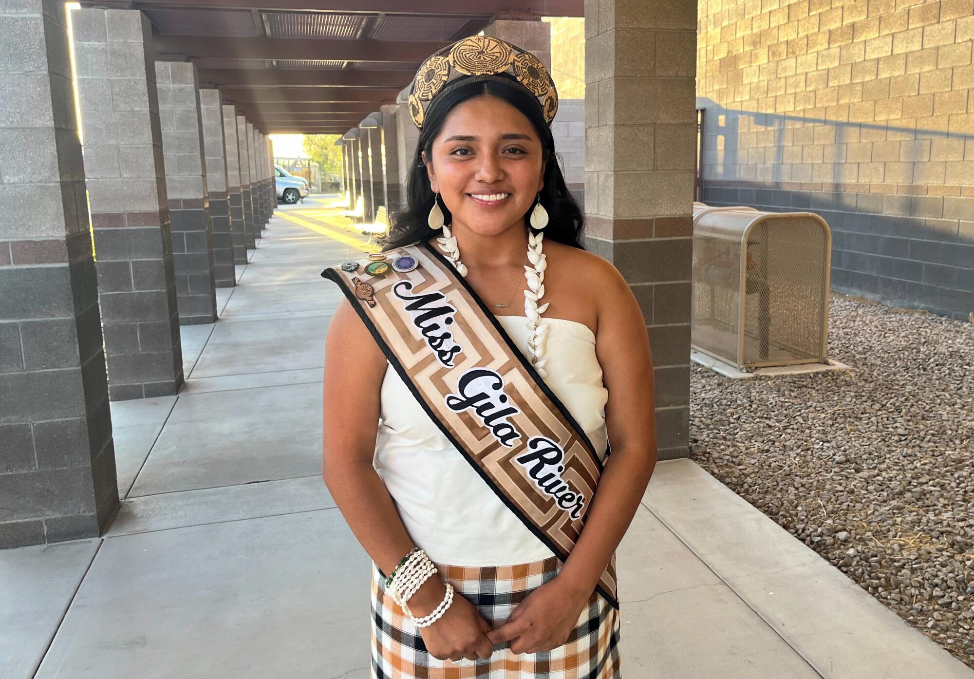 Susanna Osife wears traditional clothing, including a woven crown and a "Miss Gila River" sash.