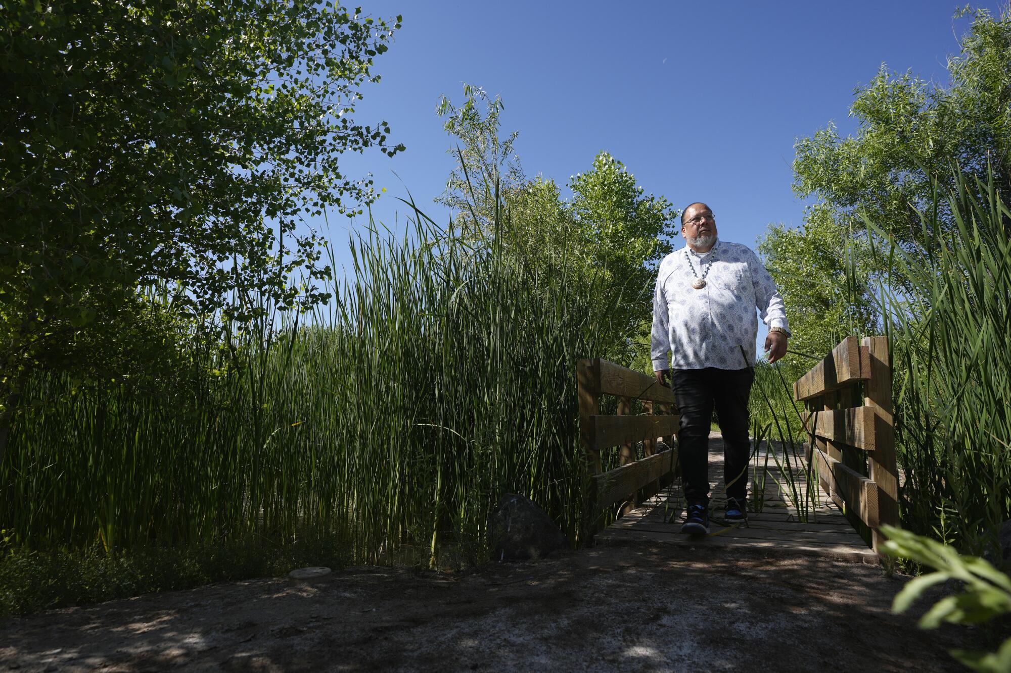 Stephen Roe Lewis walks the Gila River Interpretive Trail in Sacaton, Ariz.