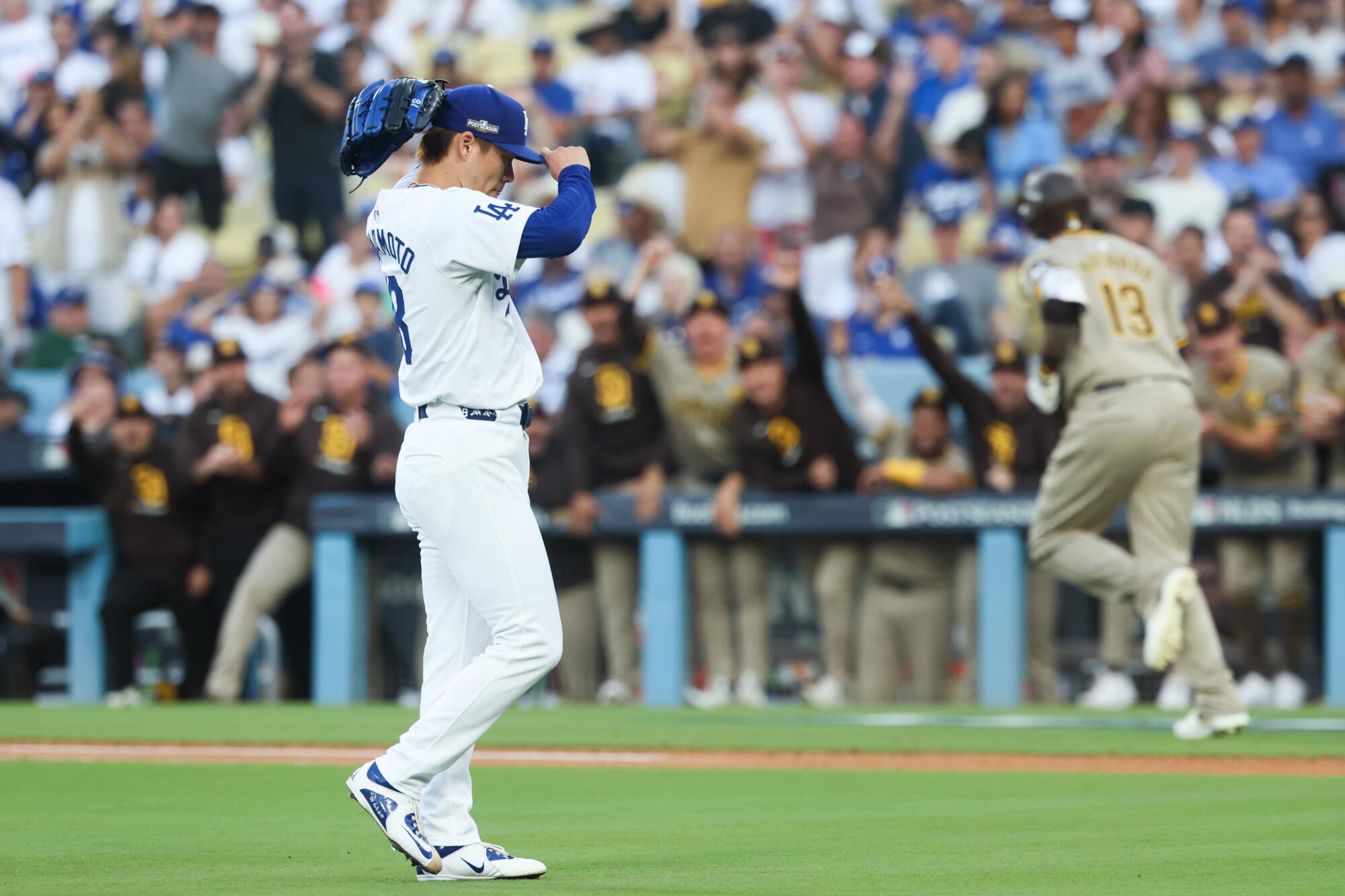 Dodgers pitcher Yoshinobu Yamamoto reacts after giving up a two-run home run to San Diego Manny Machado.