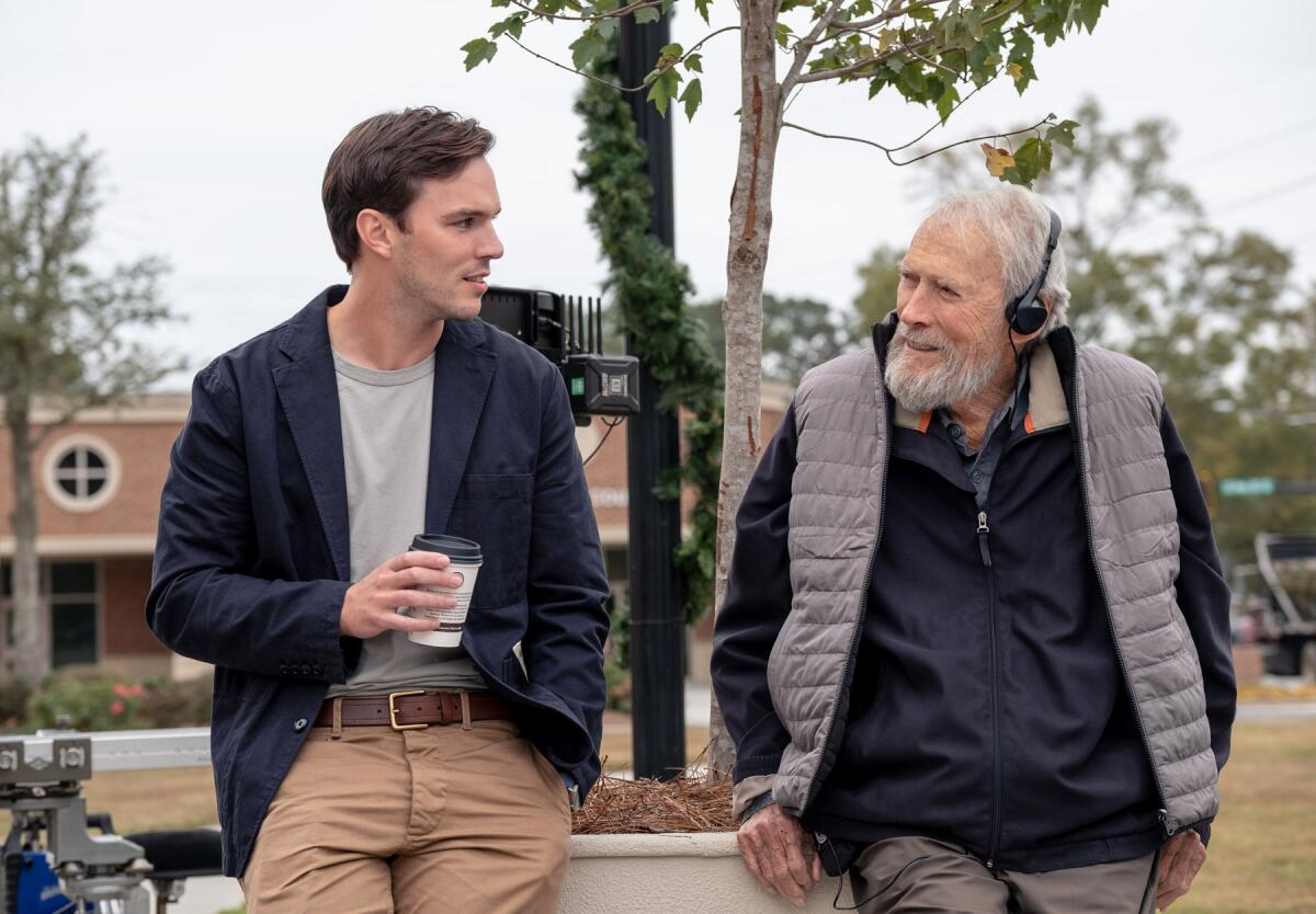 Actor Nicholas Hoult, left, and director Clint Eastwood chat on set during production on 'Juror #2.'