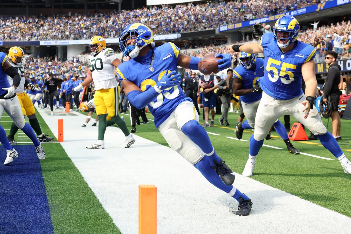 Rams safety Jaylen McCollough run into the end zone after intercepting a pass by the Packers' Jordan love near the goal line.