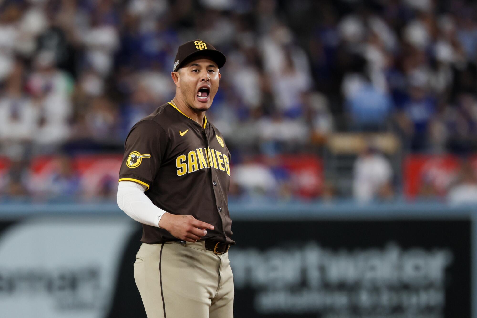 San Diego Padres third baseman Manny Machado shouts at Dodgers players in the dugout during Sunday's game.