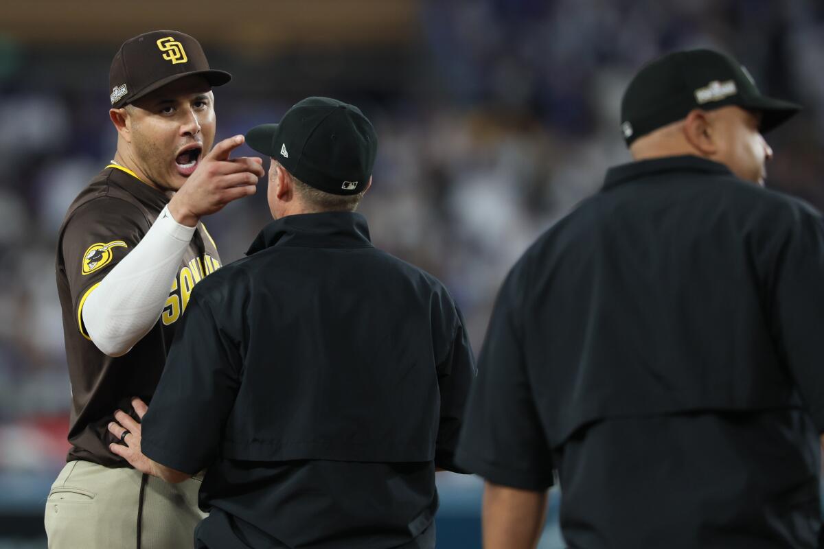 Dodgers third baseman Manny Machado talks with the umpires during the sixth inning on Sunday.