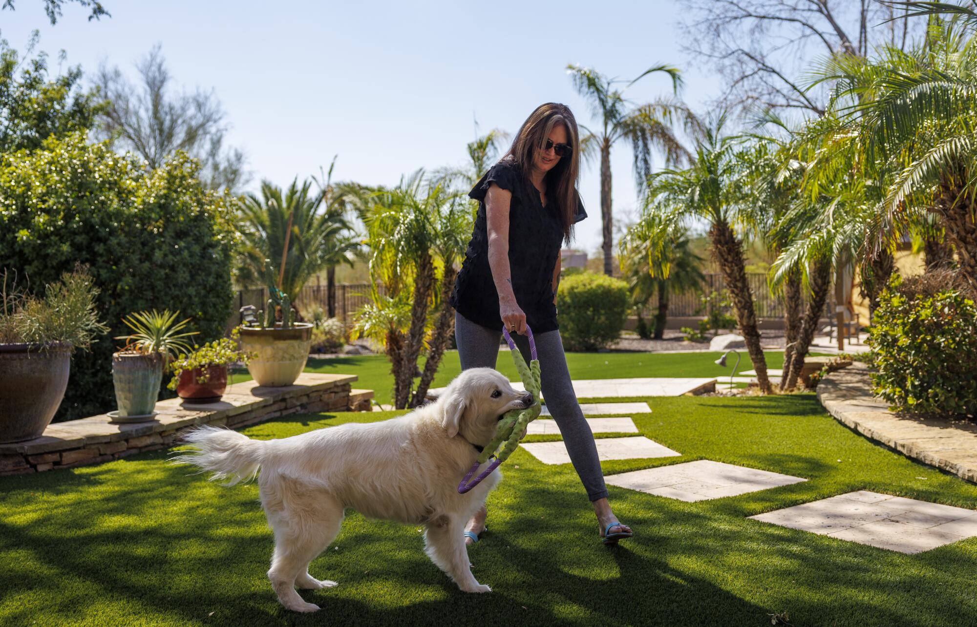 Patricia Summerland, 59, who moved from Kern County to Glendale, Ariz., last summer, plays with her daughter's dog Jake.