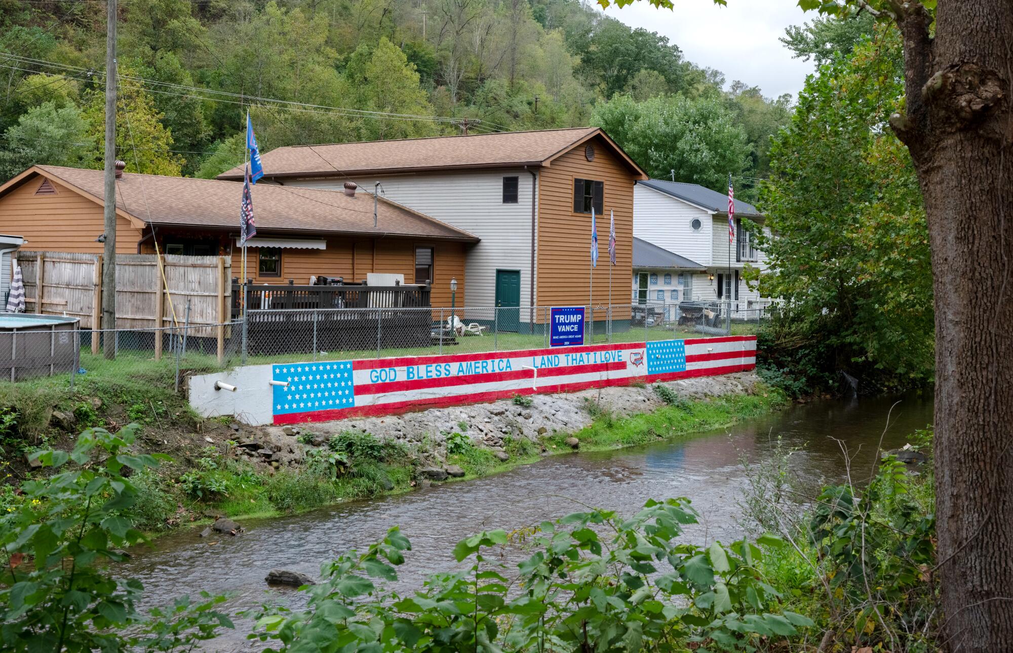 A home along Island Creek in Chauncey, W.Va., proudly displays its support of former President Trump.