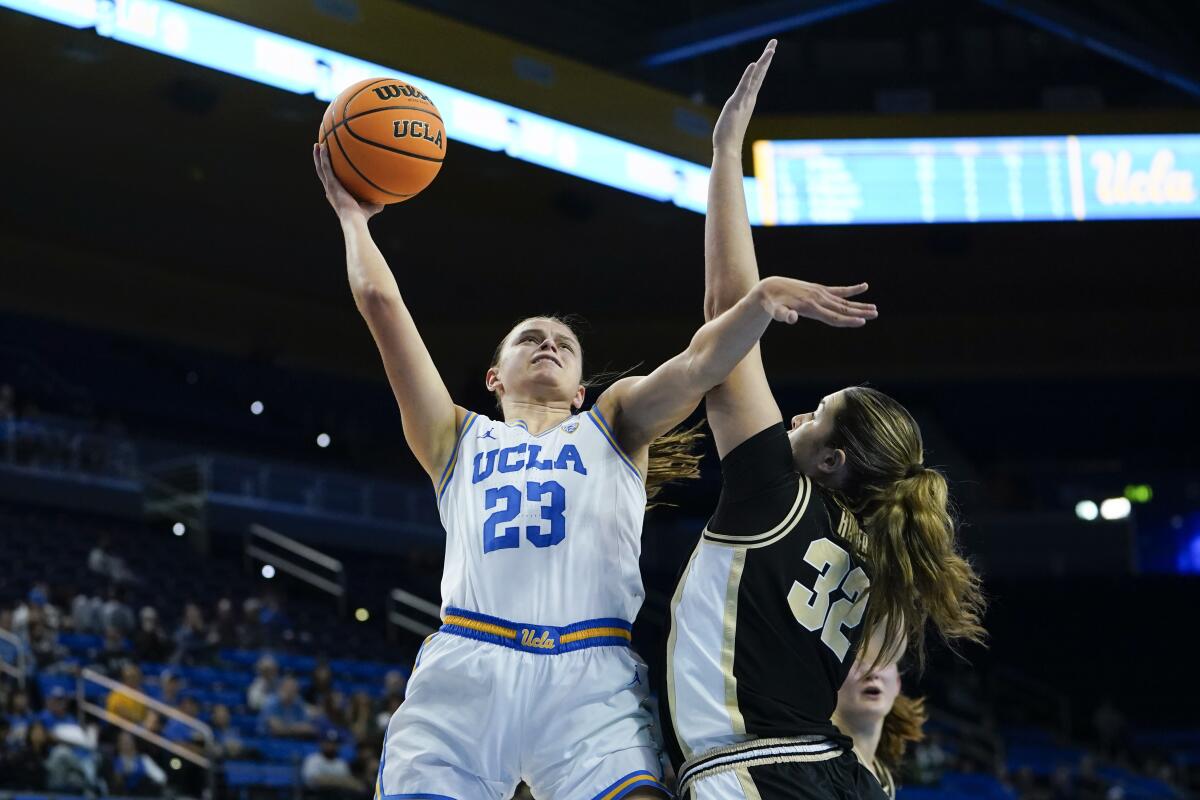 UCLA forward Gabriela Jaquez shoots over Purdue forward Alaina Harper.