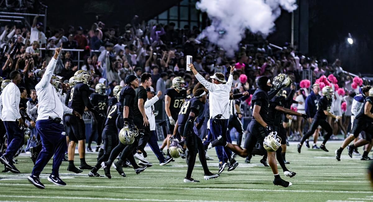 St. John Bosco launches victory celebration after stopping Orange Lutheran on game's final play for 28-24 win.