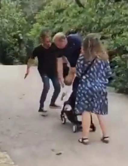 The man winds his hand back to pretend to slap the baby