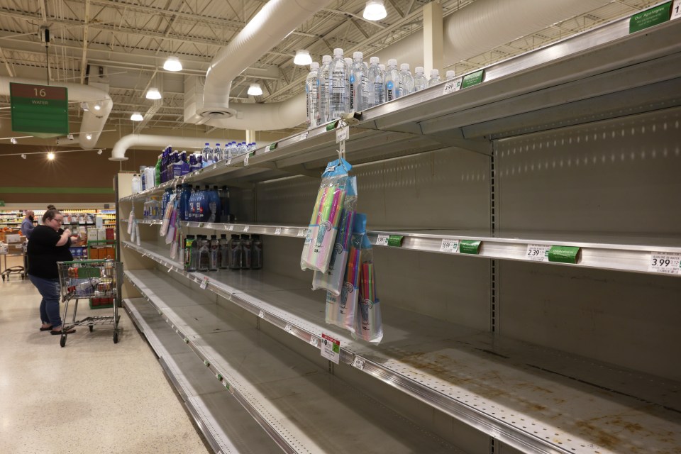 Shelves at a grocery store are empty of bottled water in St. Petersburg