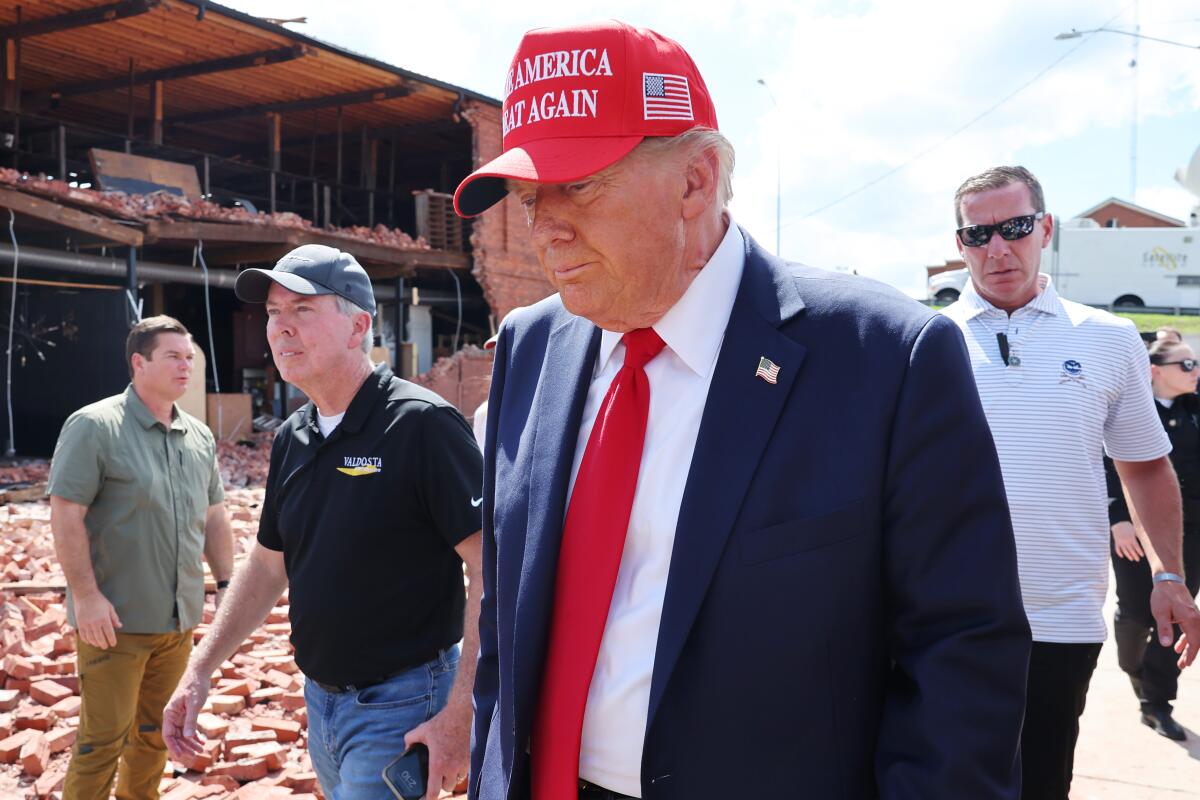 Donald Trump visits a furniture store in Valdosta, Ga., damaged by Hurricane Helene.