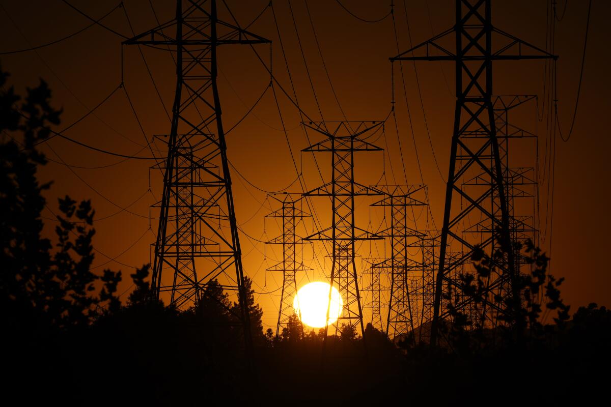 The sun sets behind power lines in the San Fernando Valley.