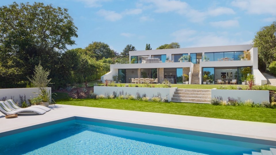 The property in Devon has a large swimming pool at the front of it