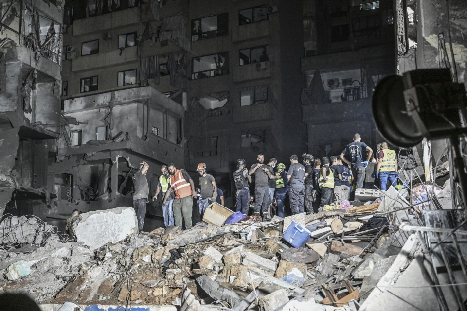 Lebanese civil defense and emergency teams conduct a search and rescue operation following the strike