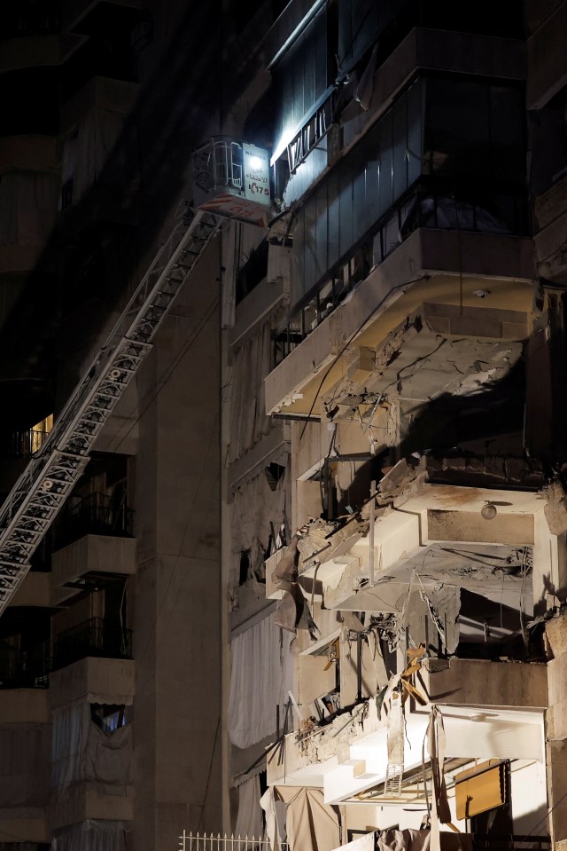 A damaged building stands at the site of the airstrike