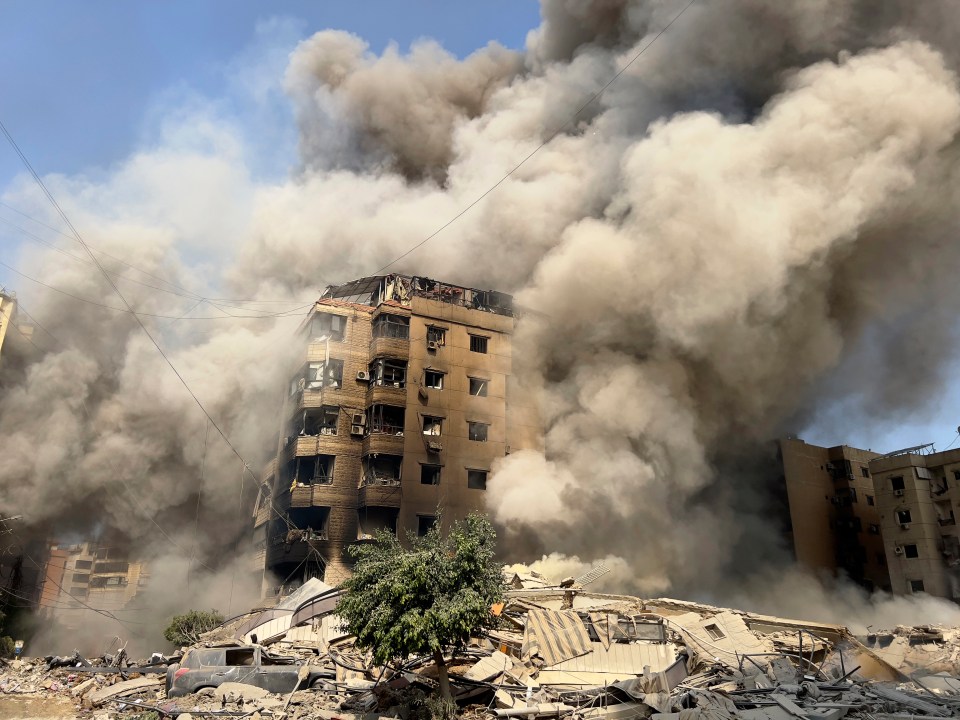 Smoke rises as a building collapses in Beirut’s southern suburbs in Lebanon in late September