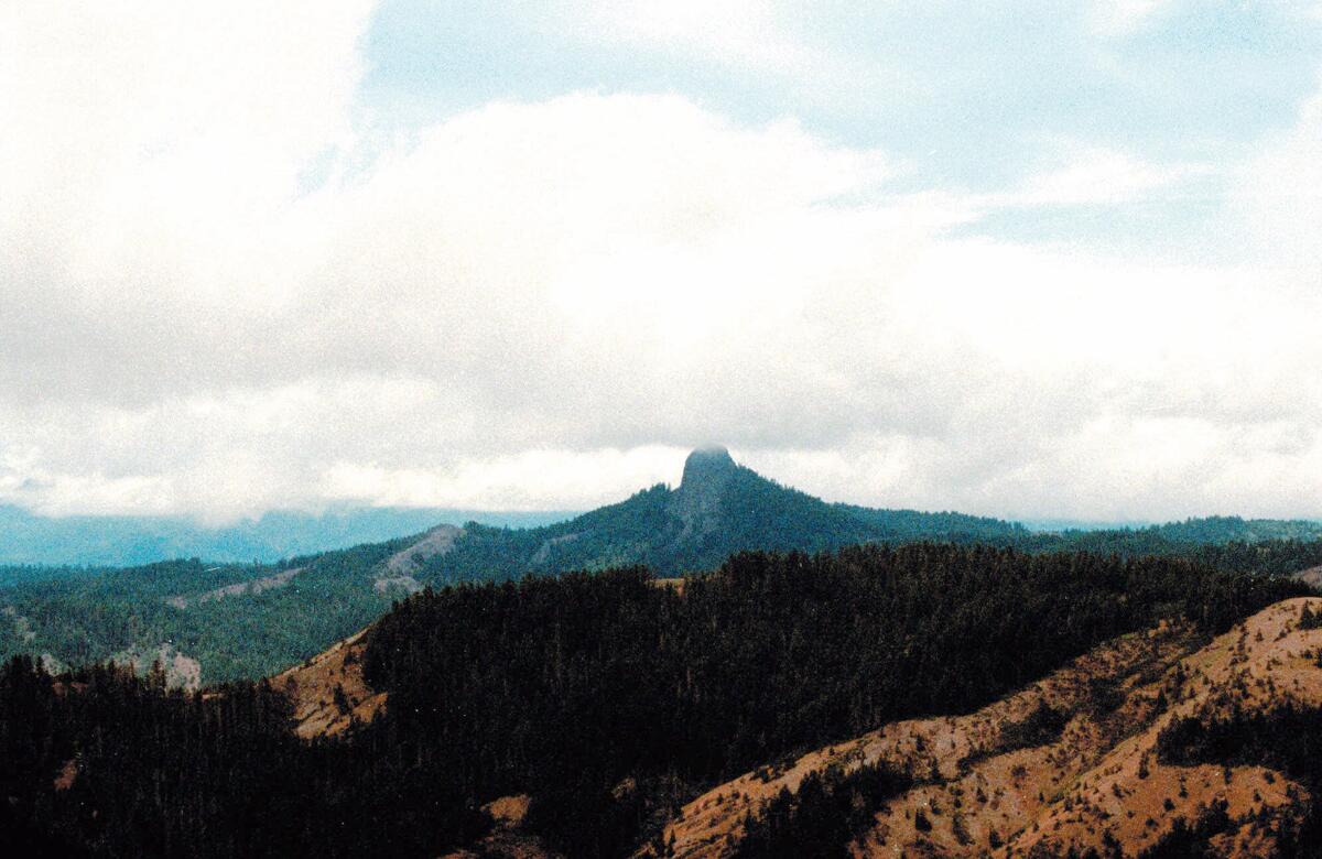 Pilot Rock rises into the clouds in the Cascade-Siskiyou National Monument near Lincoln, Ore.