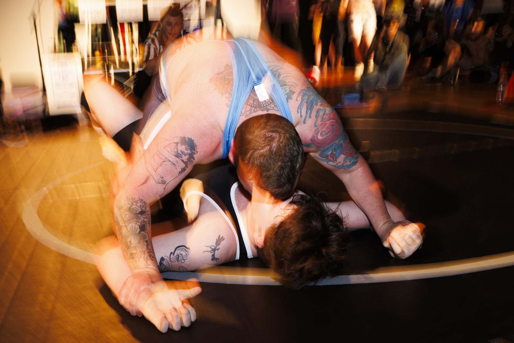 Landon St. James "Chaos King" takes down August Rain with a kiss pin at the Trans Dudes of LA "T Boy Wrestling" event.