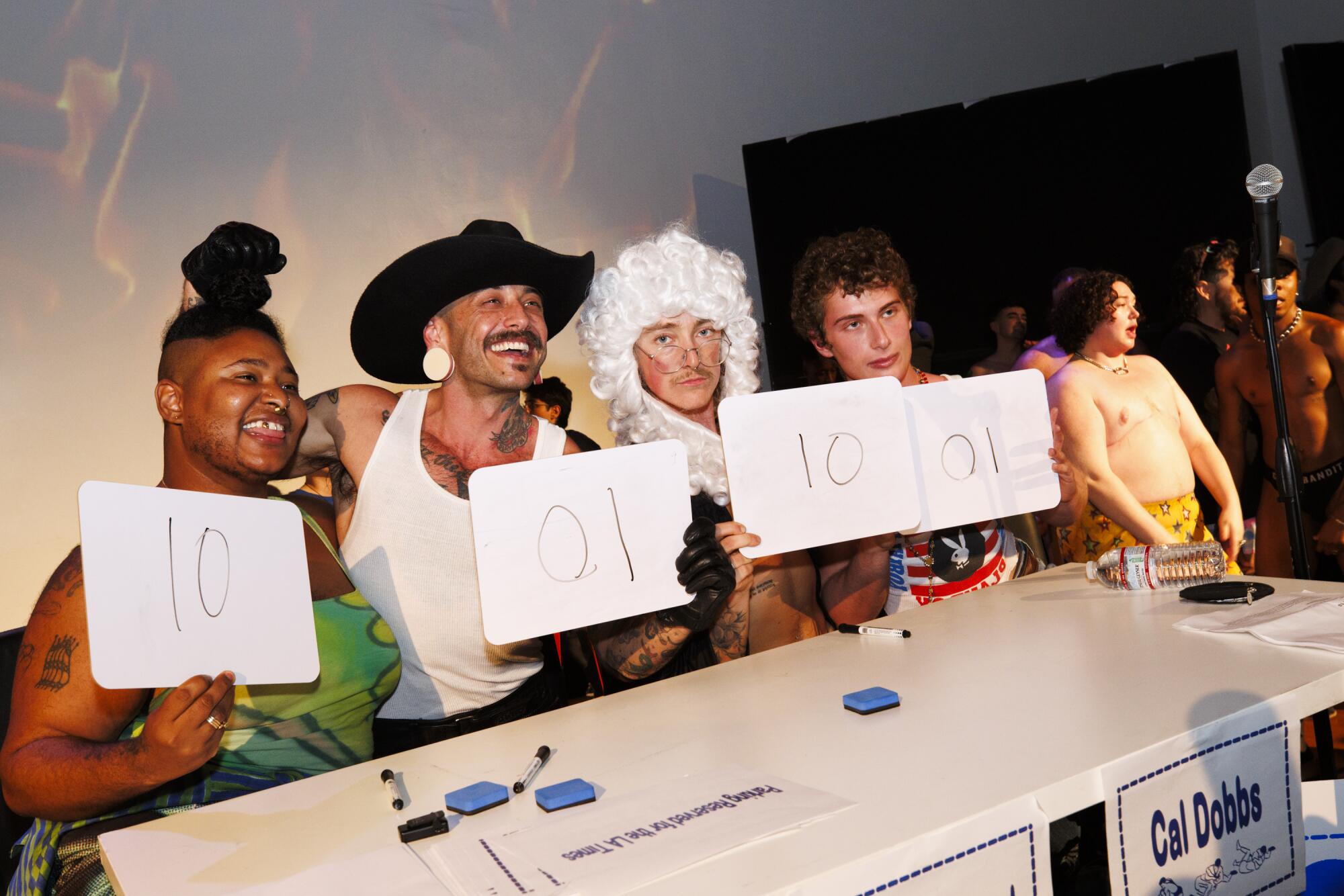 The judges panel presents its scores at the Trans Dudes of LA T-Boy Wrestling event.