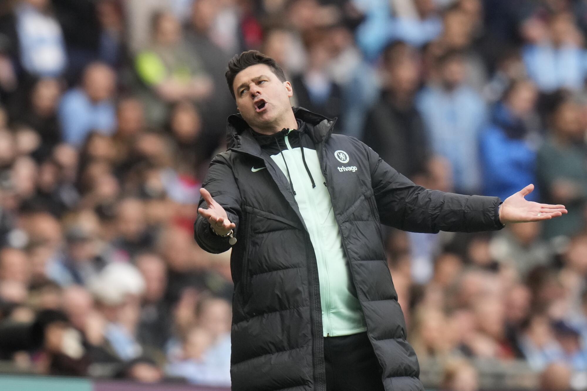 Chelsea coach Mauricio Pochettino extends his arms and reacts negatively during an English FA Cup semifinal match