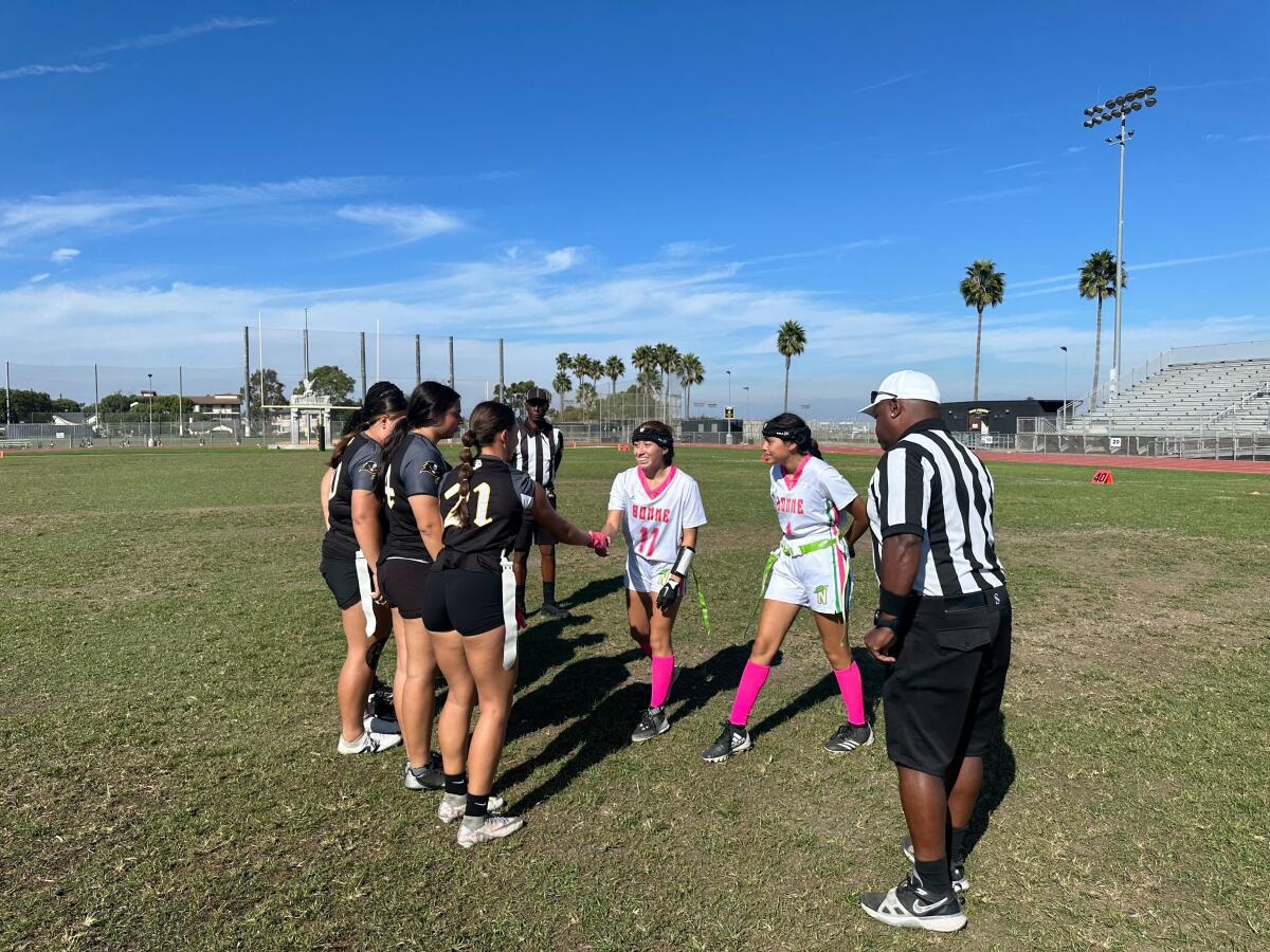 San Pedro team captains, left, shake hands with Narbonne team captains before a girls' flag football game on Oct. 11, 2024.