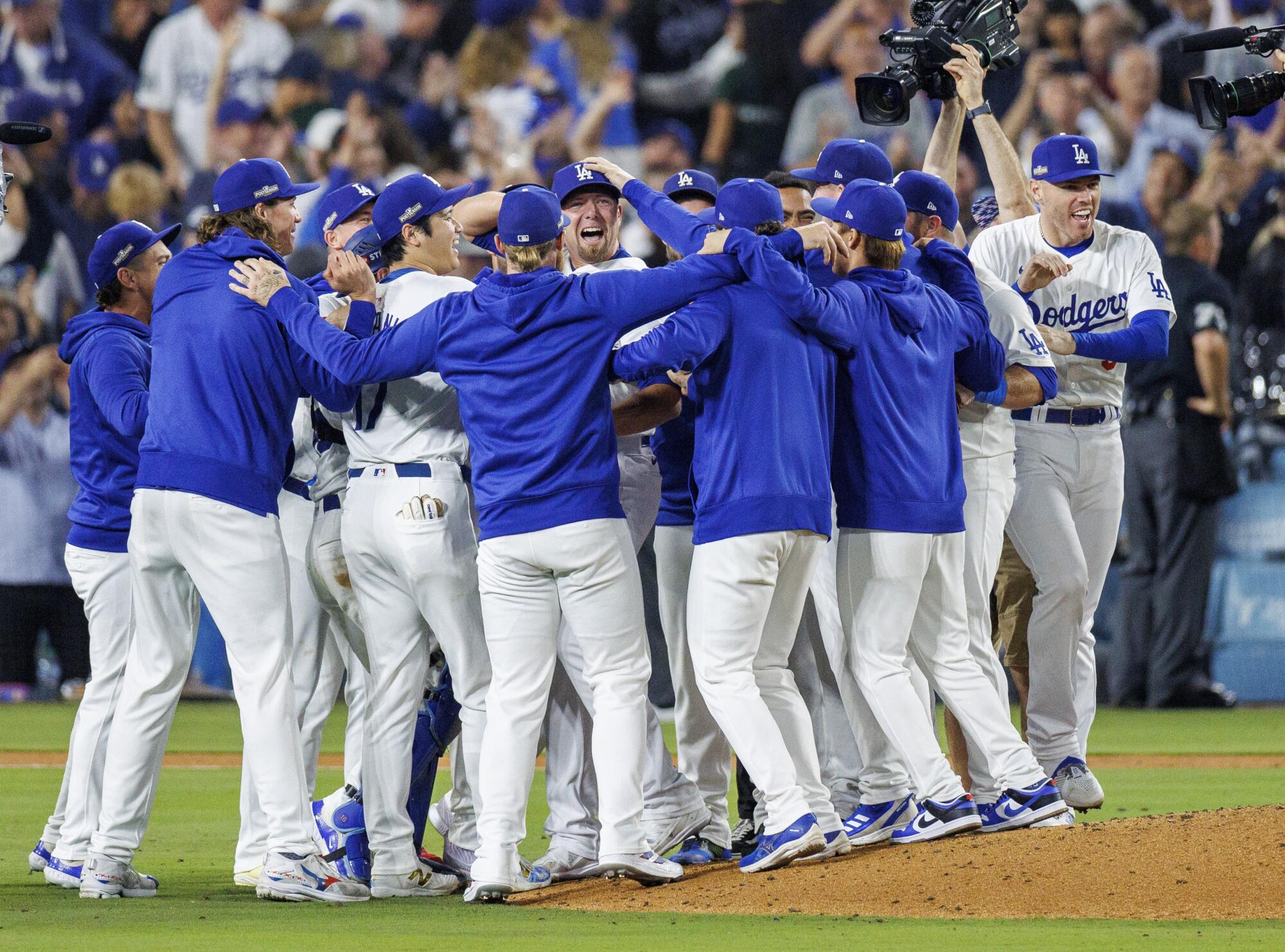 Dodgers players celebrate around reliever Blake Treinen after the final out of Game 5 of the NLDS.