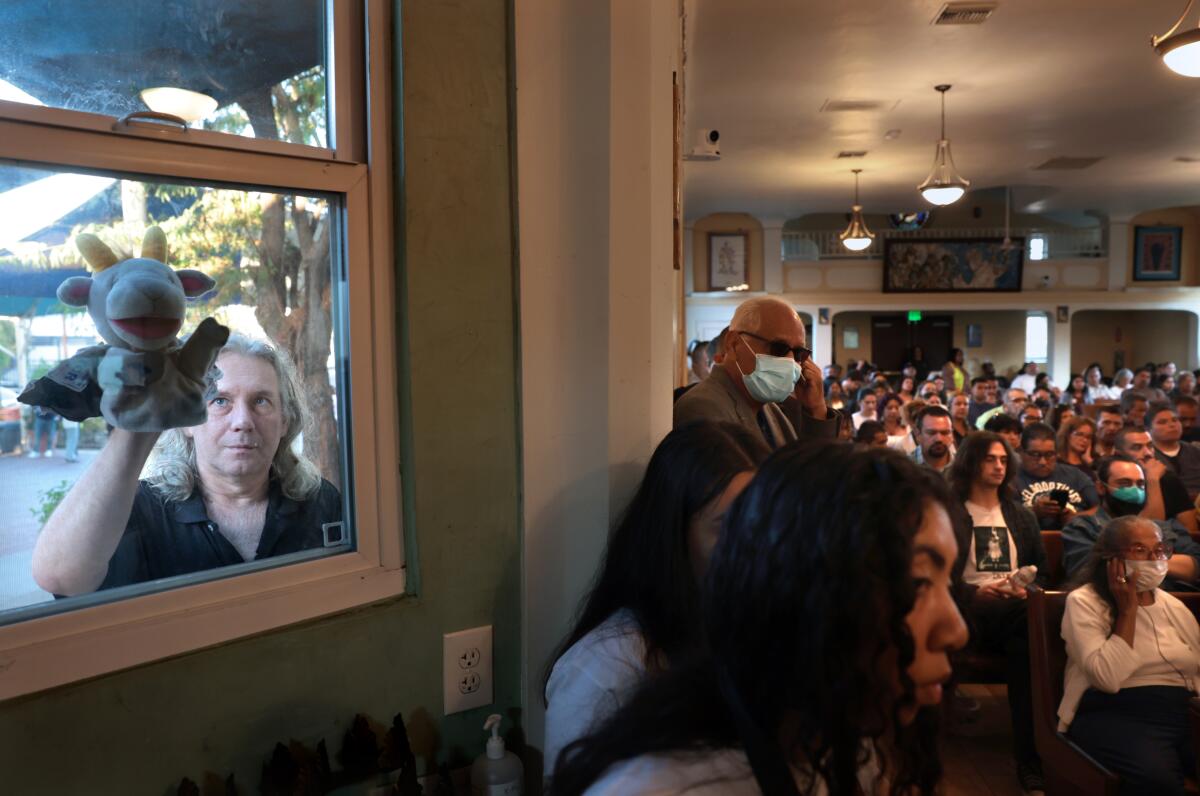 Attendees listen to Kevin de León and Ysabel Jurado debate at Dolores Mission Church.